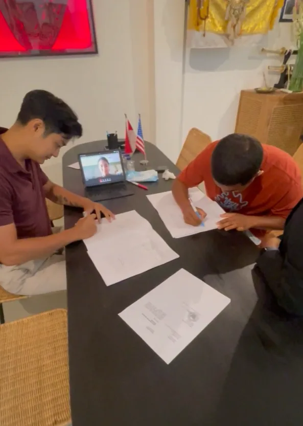 Freddy coordinating documents with a Bali property buyer
